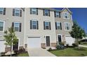 Townhomes with attached garages, landscaped lawns, and symmetrical design at 904 Romeria Dr, Durham, NC 27713