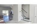 Inviting foyer with staircase and an open view into the dining area at 904 Romeria Dr, Durham, NC 27713
