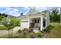 Inviting home featuring a cozy front porch with rocking chair and manicured landscaping at 1009 Morrison Dr, Durham, NC 27703