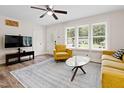Inviting living room featuring wood floors, a ceiling fan, natural light, and neutral-colored furniture at 1014 E Club Blvd, Durham, NC 27704