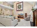 Spacious living room with high ceilings, a cozy couch, and a star quilt on the wall at 1025 Kingsway Dr, Apex, NC 27502