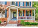 Inviting front porch with hanging plants and red-brick accents on a charming home at 105 Wittenham Dr, Cary, NC 27519