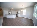 Eat-in kitchen offers stainless appliances, granite countertops, and a dining area with stylish chandelier lighting at 109 Ambergate Ct, Rocky Mount, NC 27804