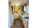 Functional kitchen featuring ample cabinet space, stainless steel sink, and a vintage aesthetic at 109 Stephens St, Chapel Hill, NC 27516