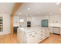 Bright, spacious kitchen features a marble island, white cabinetry, stainless appliances, and wood beam accents at 1120 Berwyn Way, Raleigh, NC 27615
