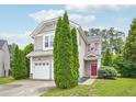 Charming two-story home with a red front door and green evergreens at 13 Pegram Ct, Durham, NC 27703