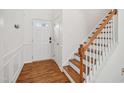 Bright foyer with wood floors, white walls, and a staircase to the upper level at 13 Pegram Ct, Durham, NC 27703