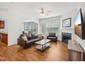 Comfortable living room with fireplace, ceiling fan, and view to the dining area at 13 Pegram Ct, Durham, NC 27703
