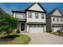 Inviting two-story home with a well-manicured lawn and a convenient two-car garage at 134 Cotten Dr, Morrisville, NC 27560