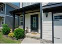 Close-up of a home's inviting front entry with manicured shrubs and a welcoming door at 134 Cotten Dr, Morrisville, NC 27560
