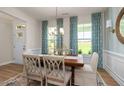 Formal dining room showcasing a stylish chandelier, six seats, and two bright windows at 1412 Main St, Lillington, NC 27546