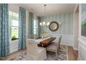 Elegant dining room with wood table, chandelier, area rug, and windows with patterned drapes at 1412 Main St, Lillington, NC 27546