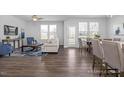 Open-concept living room with wood floors and lots of natural light at 1412 Main St, Lillington, NC 27546