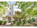 Inviting townhome showcasing manicured landscaping, brick accents, and a charming covered entrance at 1427 Van Page Blvd, Raleigh, NC 27607
