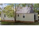 A view of the house exterior painted in light-color with windows around at 1512 Oxford Rd, Henderson, NC 27536