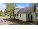 Picture shows the house's back, the exterior is painted light with windows all around at 1512 Oxford Rd, Henderson, NC 27536
