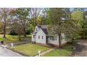 Attractive exterior of a charming home with green lawn and mature trees adding to its appeal at 1512 Oxford Rd, Henderson, NC 27536
