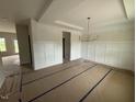 Bright dining room featuring wainscoting and a modern chandelier at 162 Tuskeegee Dr, Smithfield, NC 27577