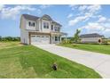 Beautiful two-story home with an inviting front yard and a long driveway at 162 Tuskeegee Dr, Smithfield, NC 27577