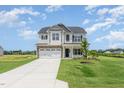Charming two-story home with a well-manicured lawn and covered front porch at 162 Tuskeegee Dr, Smithfield, NC 27577