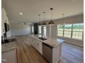 Modern kitchen with stainless steel appliances, granite countertops, and an island at 162 Tuskeegee Dr, Smithfield, NC 27577