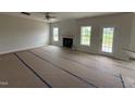 Living room with a ceiling fan, multiple windows, and fireplace at 162 Tuskeegee Dr, Smithfield, NC 27577