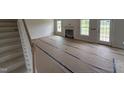 Open-concept living room with fireplace, large windows, and a door leading to the outside at 162 Tuskeegee Dr, Smithfield, NC 27577