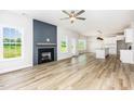 Spacious living room featuring a fireplace, wood flooring, and abundant natural light at 162 Tuskeegee Dr, Smithfield, NC 27577