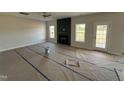 Spacious living room with a cozy fireplace and a walk out door to the backyard at 162 Tuskeegee Dr, Smithfield, NC 27577