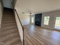 Bright living room with a fireplace, ceiling fan, and sliding door to the backyard at 162 Tuskeegee Dr, Smithfield, NC 27577