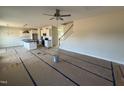 Open-concept living space with an island kitchen, white cabinets and an adjoining staircase at 162 Tuskeegee Dr, Smithfield, NC 27577