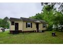 A charming single-story home with black shutters and a well-maintained lawn on an overcast day at 1620 Old Wilson Rd, Rocky Mount, NC 27801