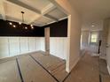 Elegant dining room featuring a coffered ceiling, wainscoting, and a modern chandelier at 188 Tuskeegee Dr, Smithfield, NC 27577
