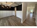 Modern dining room boasts a coffered ceiling, wainscoting, and dark accent wall at 188 Tuskeegee Dr, Smithfield, NC 27577