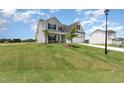 Charming gray two-story home with well-manicured lawn and attached garage at 188 Tuskeegee Dr, Smithfield, NC 27577