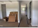Bright hallway featuring modern trim, light colored walls, and new flooring at 188 Tuskeegee Dr, Smithfield, NC 27577