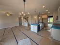 Spacious kitchen with center island, modern appliances, and an open view of the staircase at 188 Tuskeegee Dr, Smithfield, NC 27577