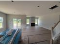Spacious living room featuring large windows, a fireplace, and sliding glass doors at 188 Tuskeegee Dr, Smithfield, NC 27577