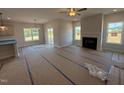 Bright living room with fireplace, large windows, and open floor plan at 188 Tuskeegee Dr, Smithfield, NC 27577