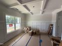 Bright Living Room showcasing a large window, modern trim work, and new flooring at 188 Tuskeegee Dr, Smithfield, NC 27577