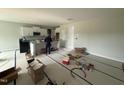 Eat-in kitchen with white cabinets and large island; still under construction at 202 Tuskeegee Dr, Smithfield, NC 27577