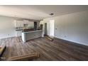 Unfinished kitchen area featuring an island, white cabinets, and waterproof flooring in an open-concept layout at 202 Tuskeegee Dr, Smithfield, NC 27577