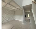 Unfinished living room with decorative wall trim, coffered ceilings, and view to the foyer and fireplace at 202 Tuskeegee Dr, Smithfield, NC 27577