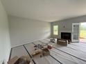 Bright living room with fireplace and glass door to patio at 202 Tuskeegee Dr, Smithfield, NC 27577