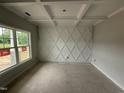 Unfinished living room featuring decorative wall trim, coffered ceilings, and a large window with a view at 202 Tuskeegee Dr, Smithfield, NC 27577