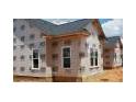 Exterior home under construction showing wood framing and white framed windows awaiting brick or siding at 219 Crescent Dr, Dunn, NC 28334