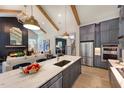 Open concept kitchen with a large island, stainless steel appliances, and modern lighting at 223 Lindo Johnson Rd, Pittsboro, NC 27312