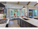 Gourmet kitchen featuring a stylish island and seamless flow to the adjacent dining area at 223 Lindo Johnson Rd, Pittsboro, NC 27312