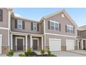 Townhome with light gray siding, a covered porch, and a single-car garage door at 228 Moyer Dr, Graham, NC 27253