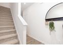 Inviting foyer featuring a staircase and a stylish mirror with decorative accents at 228 Moyer Dr, Graham, NC 27253